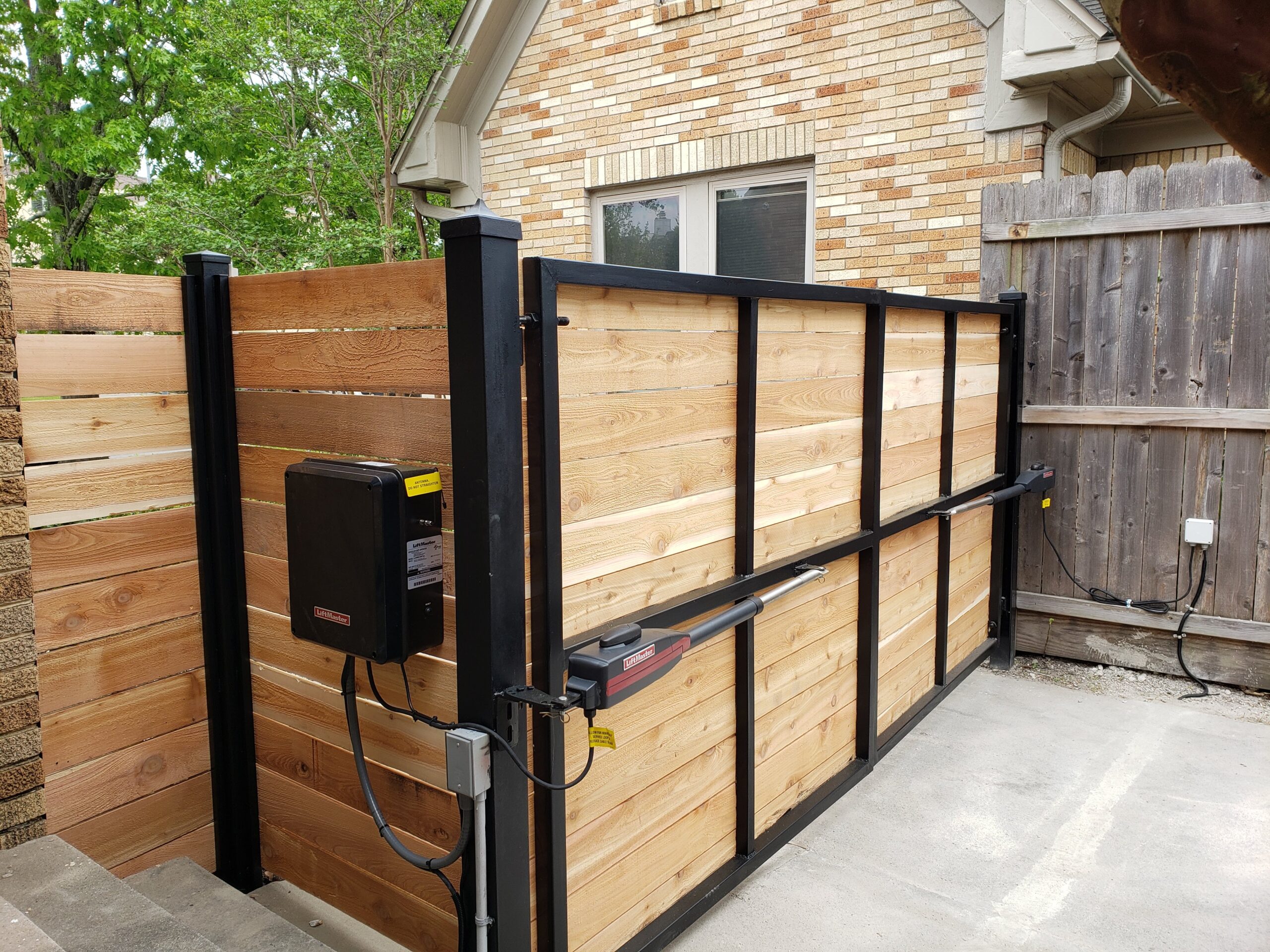 Dual LiftMaster LA400 swing gate opener installation with magnetic lock in Houston