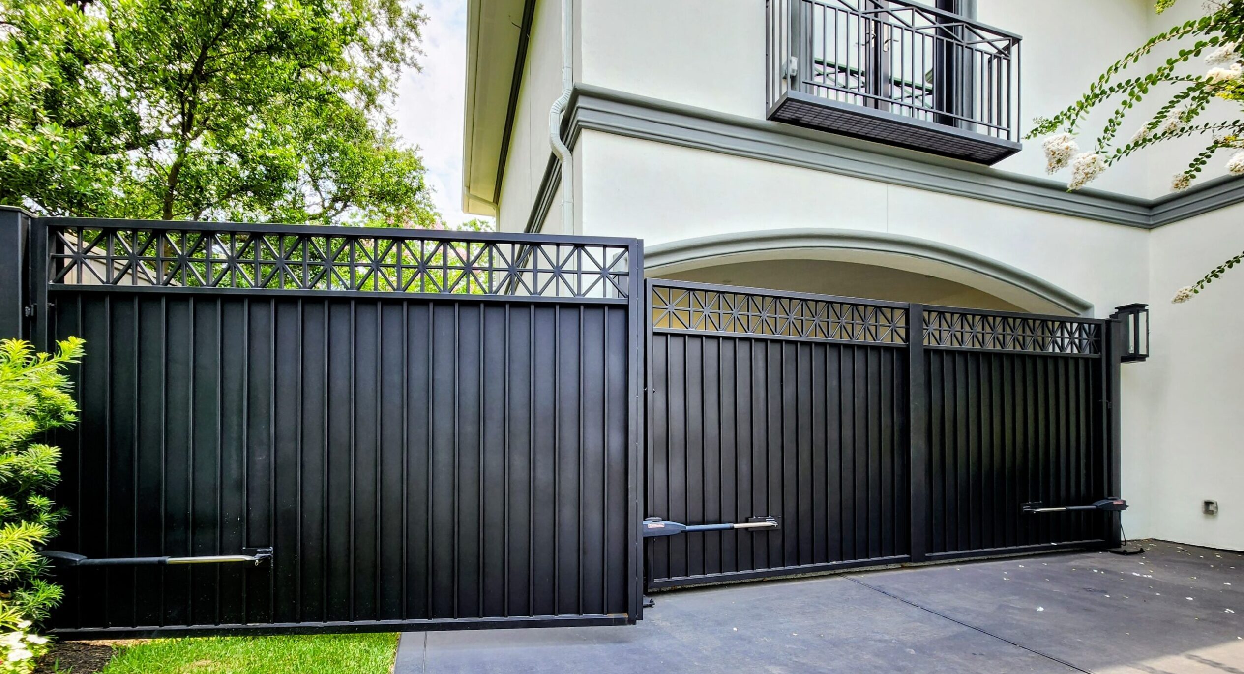 Residential driveway swing gate with automatic gate opener installed in Houston