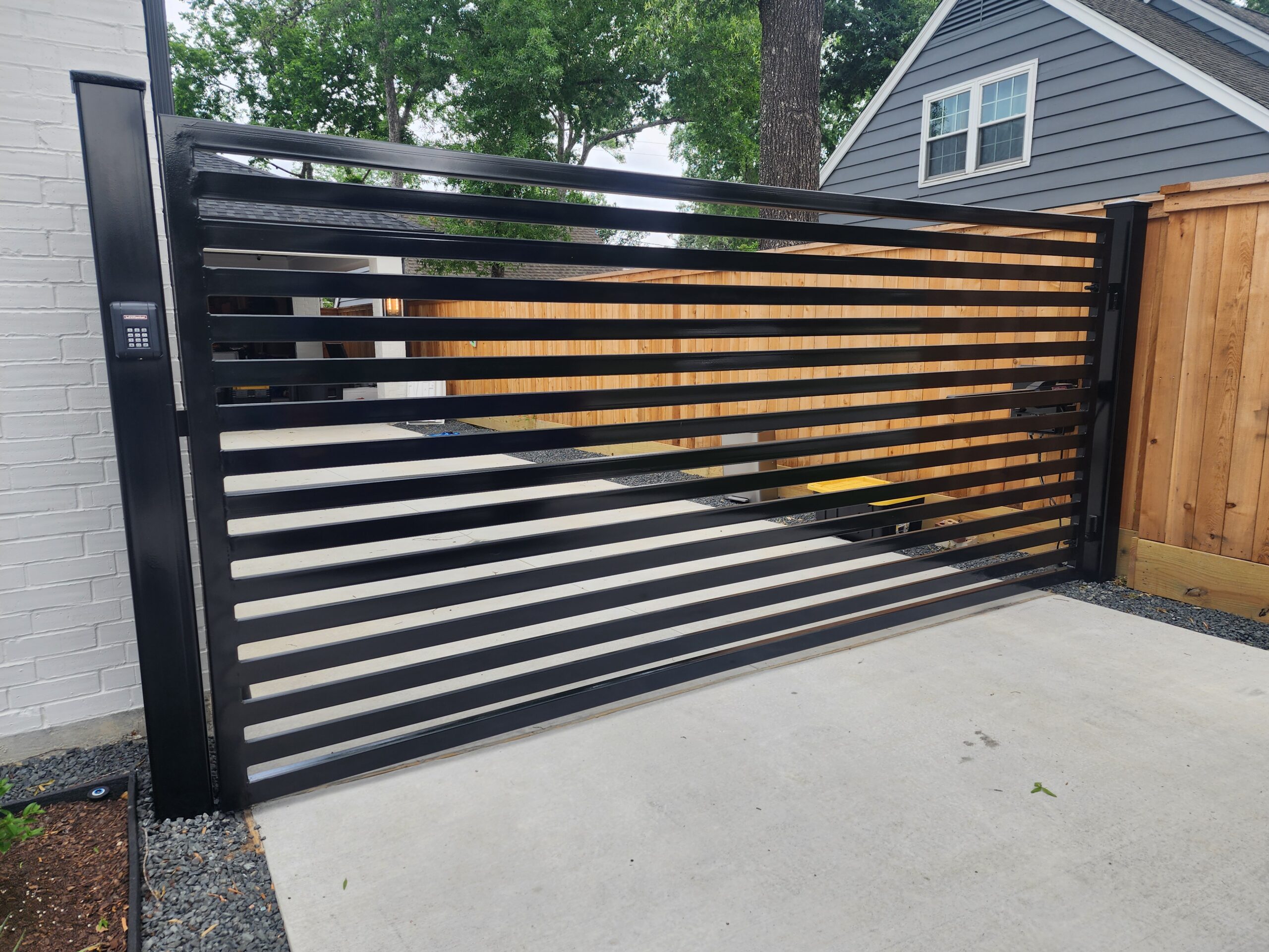 driveway gate repair project in Houston showing repaired iron gate
