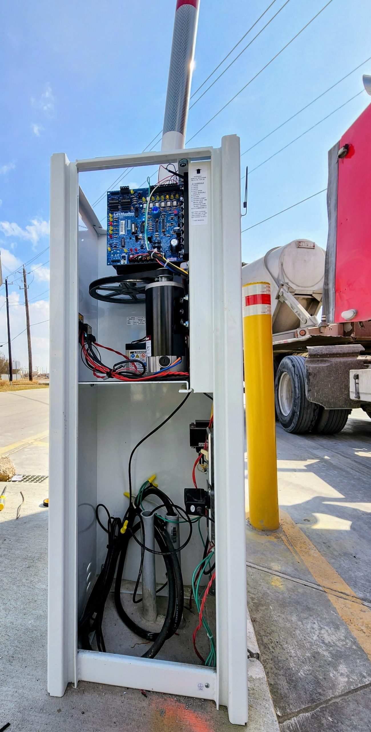 LiftMaster barrier arm and boom gate control cabinet during repair in Houston TX