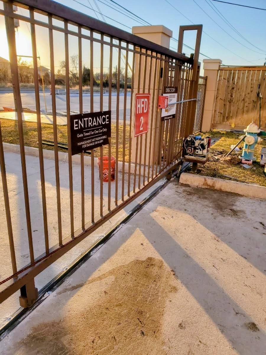 Gate opener installation in Houston showing a completed automatic gate opener system
