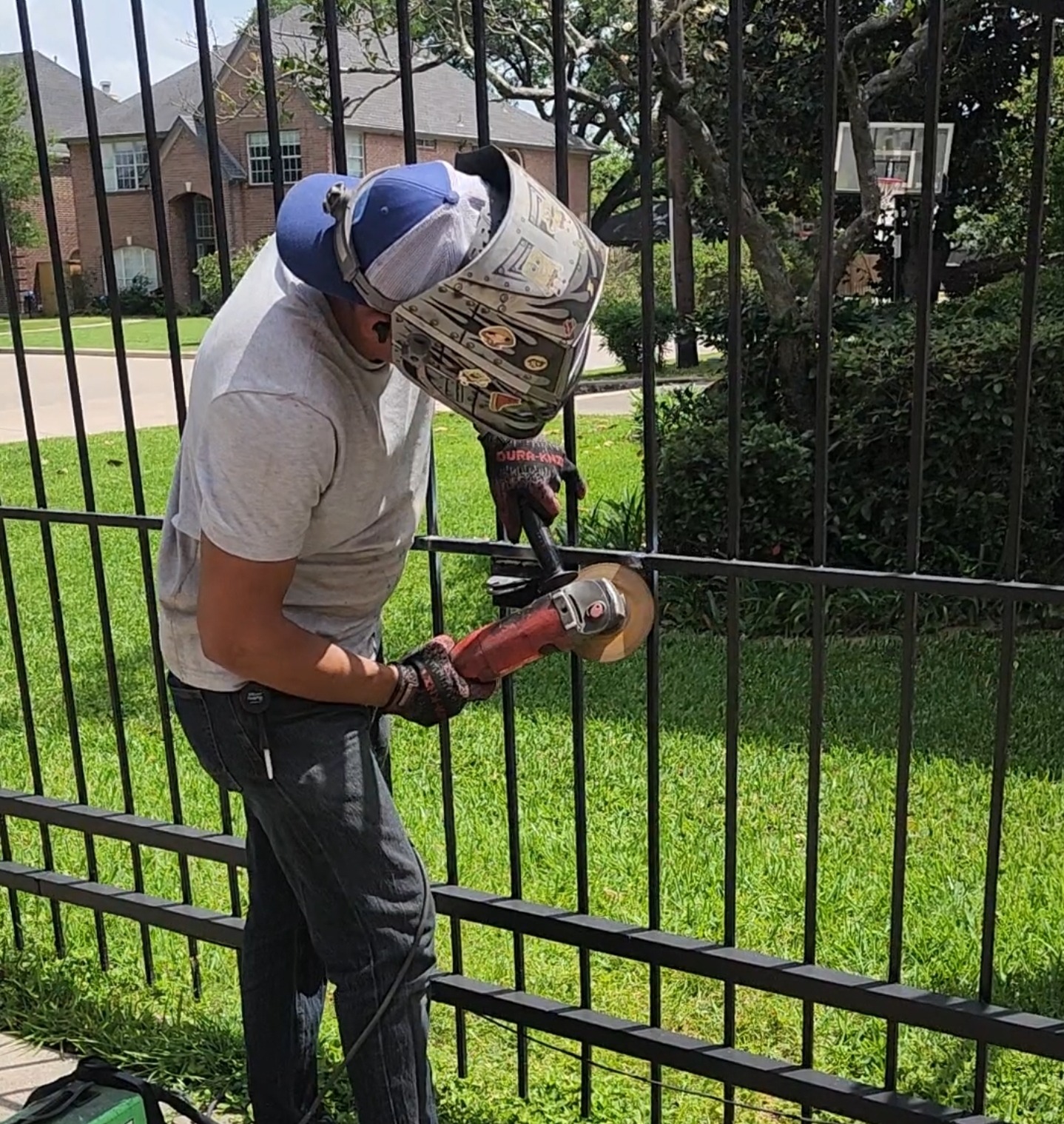 Rampart Welding technician performing metal gate and fence repair work at a Houston TX property